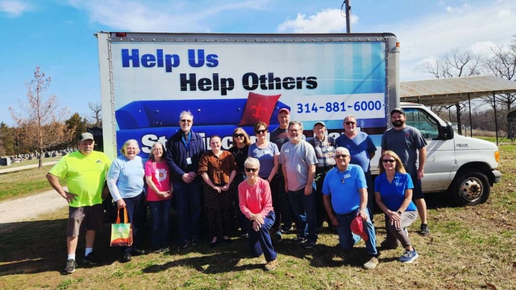 Rural Parish Clinic volunteers gathered in front of a mobile clinic