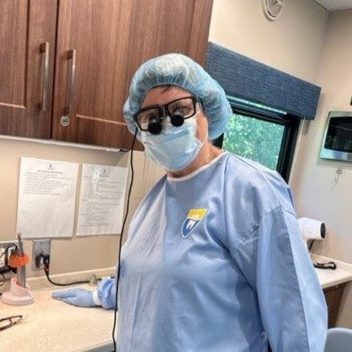 Diann Bomkamp in scrubs at the dental clinic